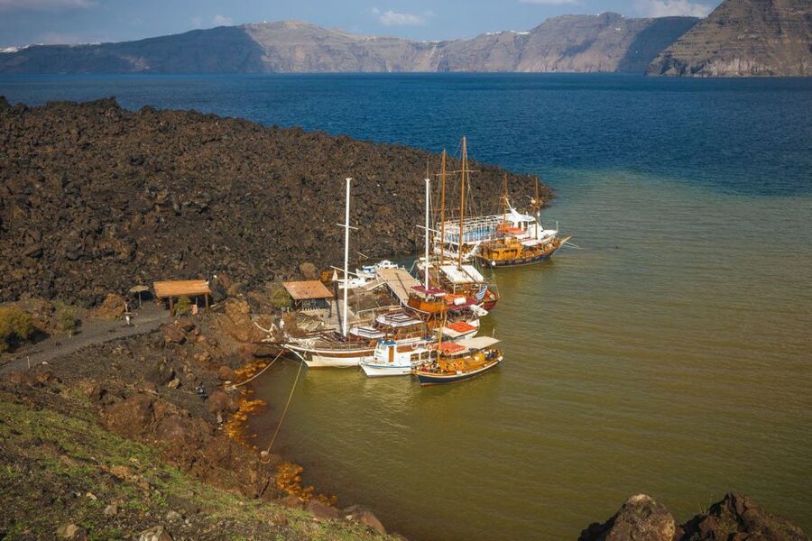 Santorini Island Bus Tour and Caldera Sunset Cruise - Nea Kameni is scenic, rough, and exposed